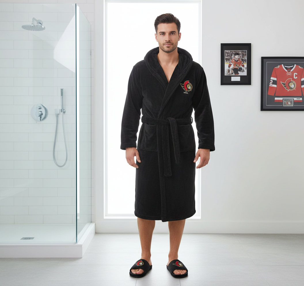 A bundle including a black hooded robe with a red and white logo on the chest and a pair of black fur slipper sandals with the same logo.