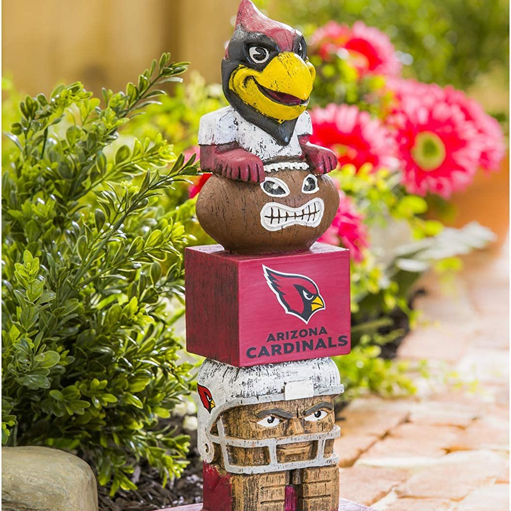 Arizona Cardinals-themed totem pole figurine with mascot on a garden path.