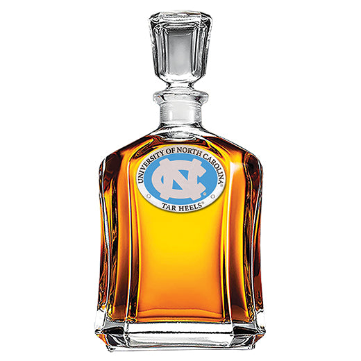 Glass decanter with University of North Carolina Tar Heels logo on a white background