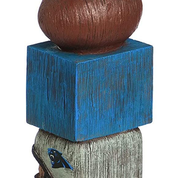 Wooden totem pole with animal figure on a blue base