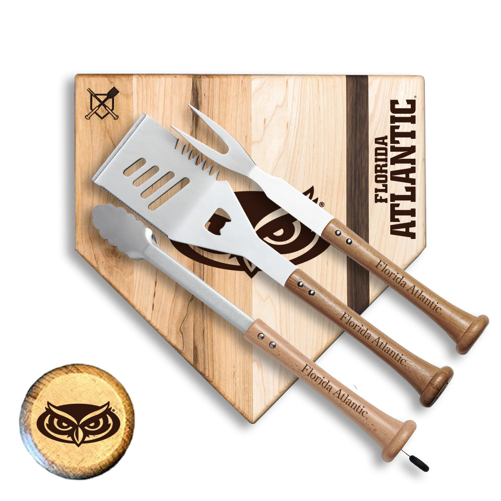 Grill spatula and fork set with wooden handles on a cutting board branded 'Florida Atlantic'.
