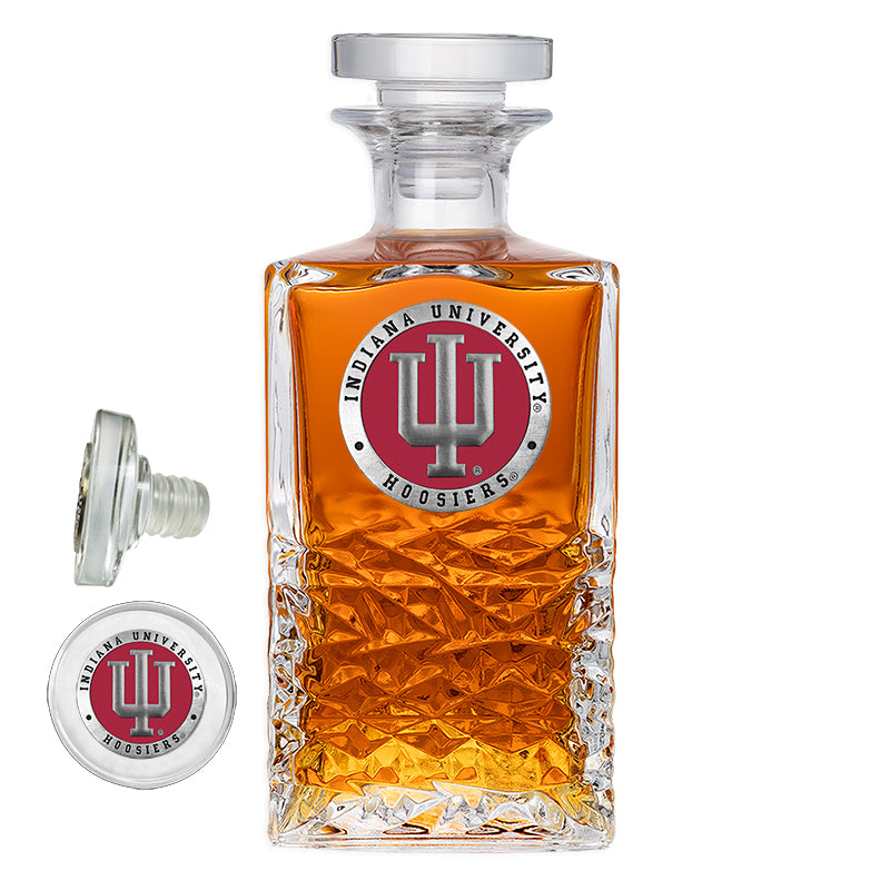 Glass decanter with Indiana University logo on a white background