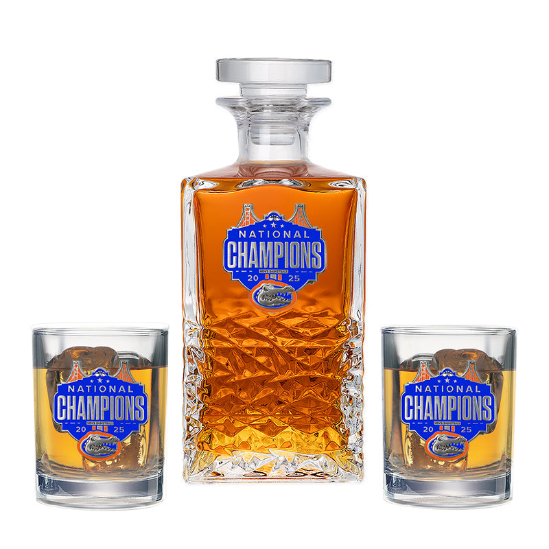 Whiskey decanter and two glasses with 'National Champions' label on a white background