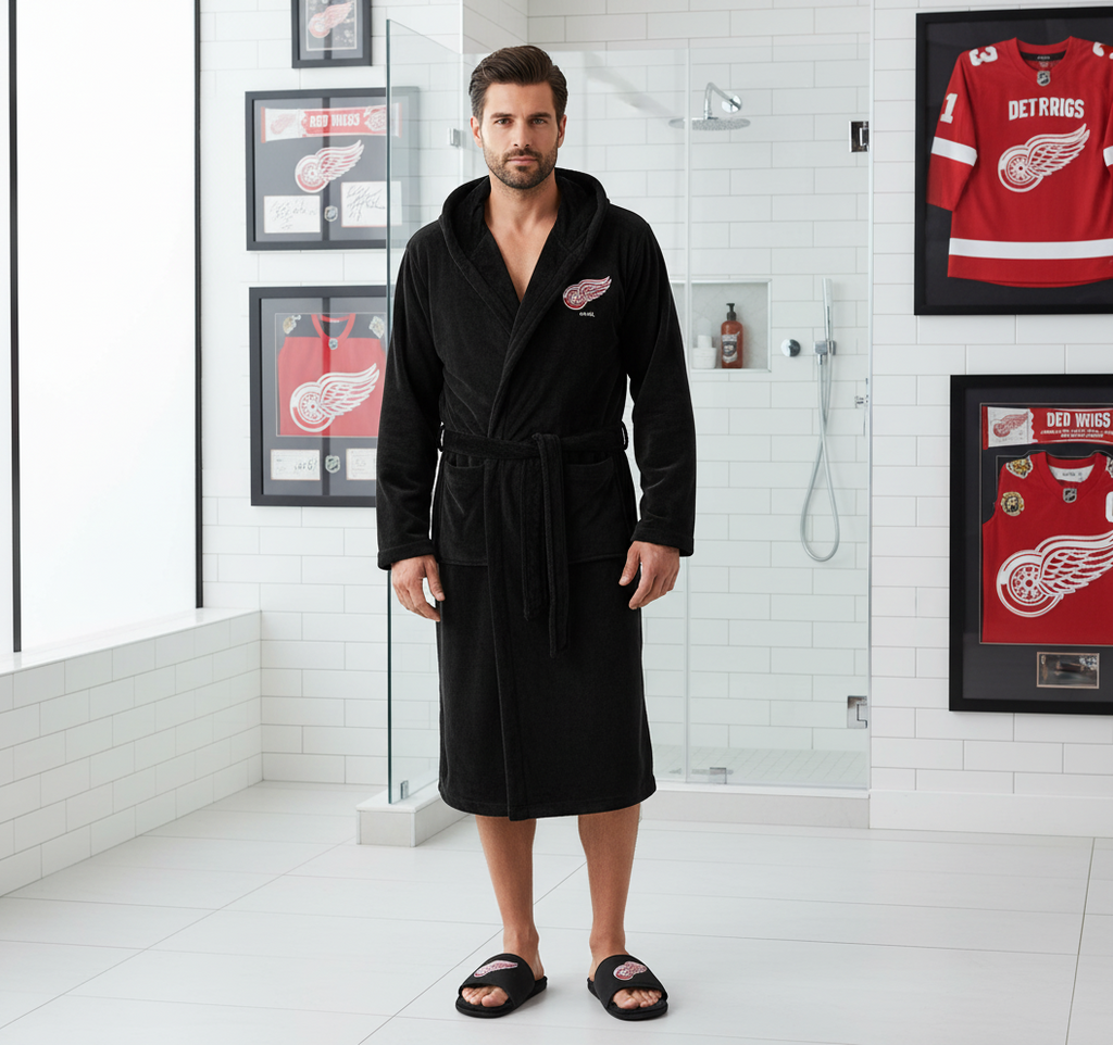 A bundle including a black faux fur hooded robe with a Detroit Red Wings logo and a pair of black faux fur slipper sandals with the same logo.