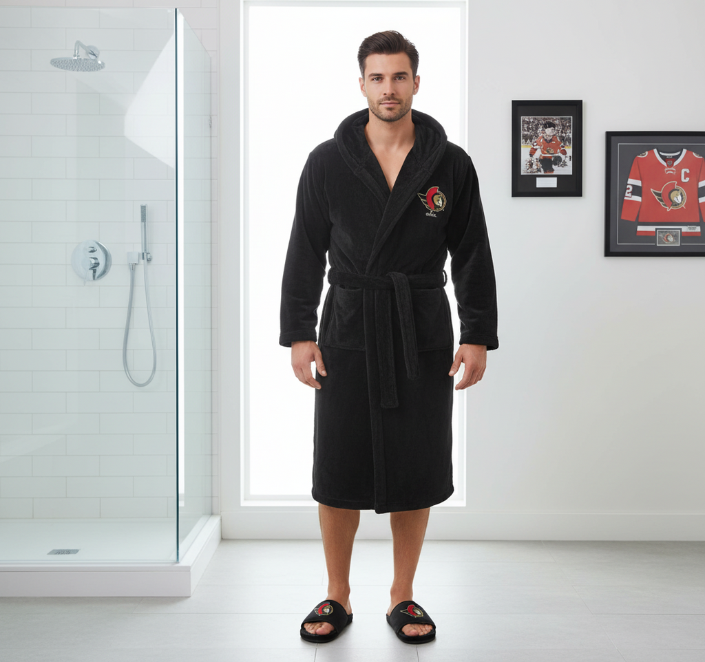 A bundle including a black hooded robe with a red and white logo on the chest and a pair of black fur slipper sandals with the same logo.