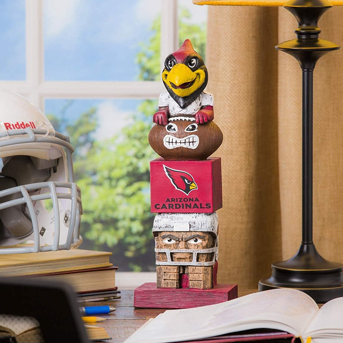 Arizona Cardinals totem figurine on a desk with books and a lamp in the background