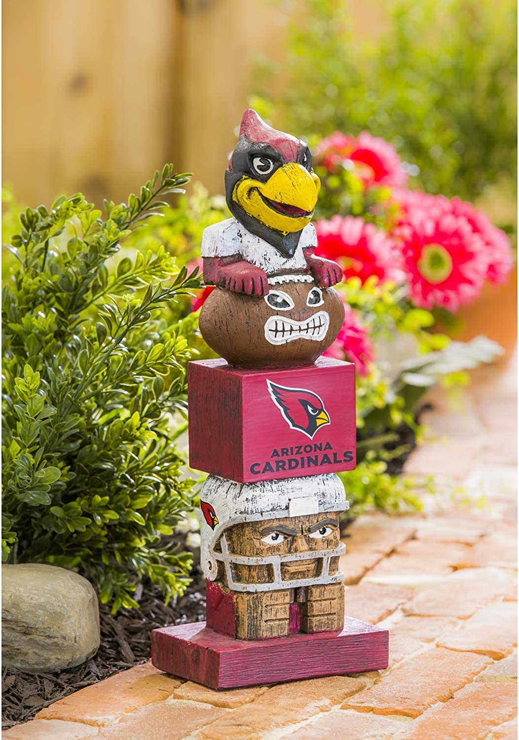 Arizona Cardinals-themed totem pole figurine with mascot on a garden path.