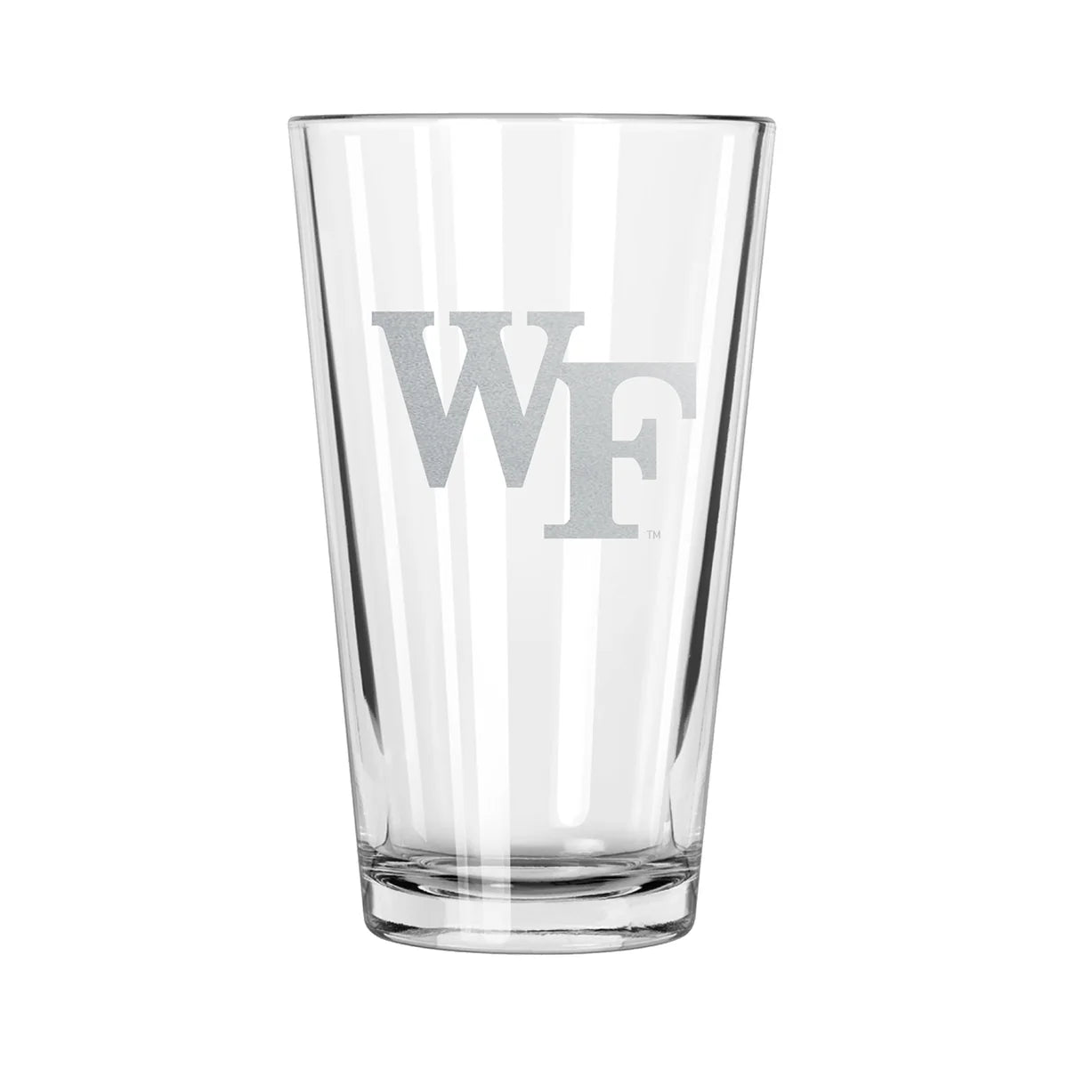 A clear pint glass with an etched design of the Wake Forest Demon Deacons logo.