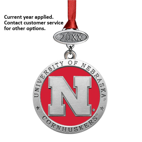 Nebraska Cornhuskers ornament with red ribbon on a white background