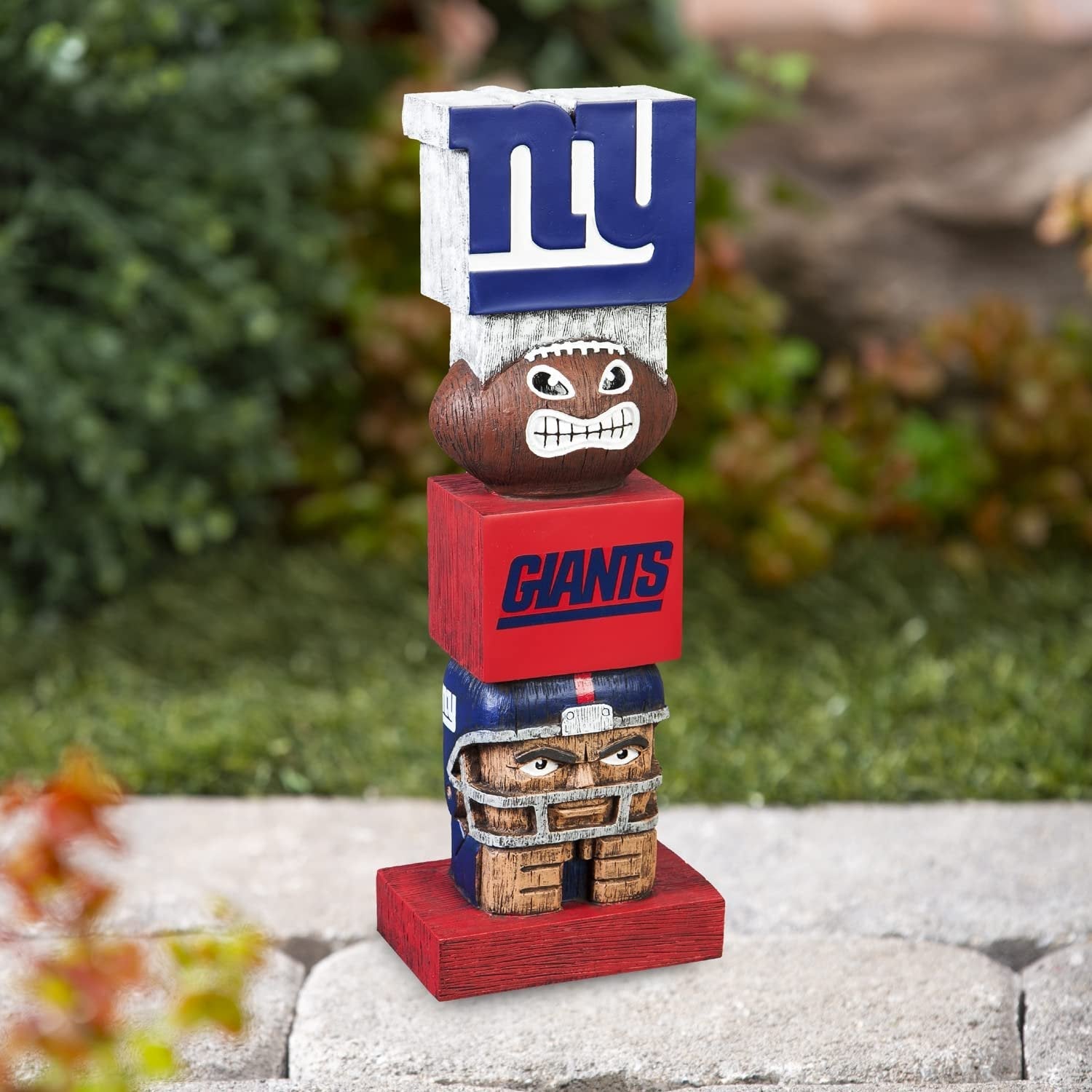 Tiki Totem with New York Giants logo and football design on a stone surface with greenery in the background