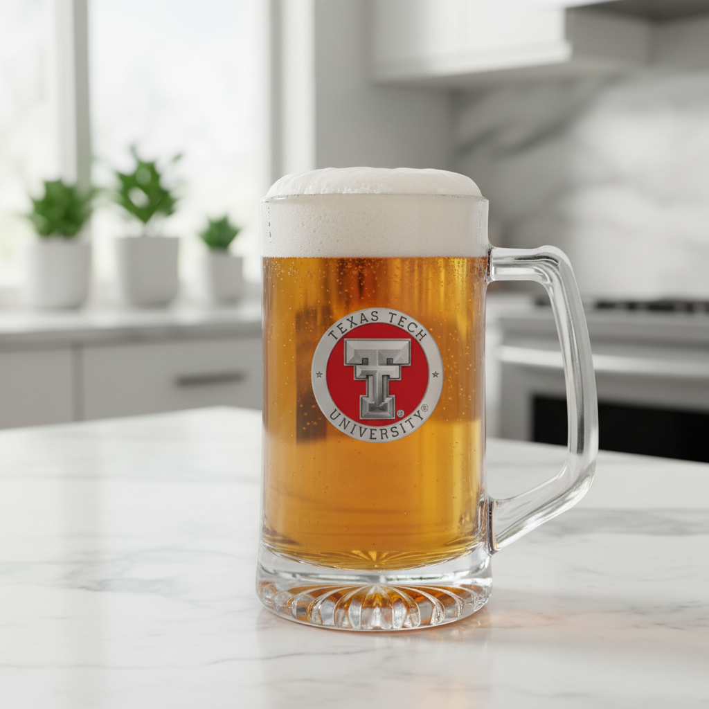 A clear glass stein with a red and white Texas Tech University logo on the front.