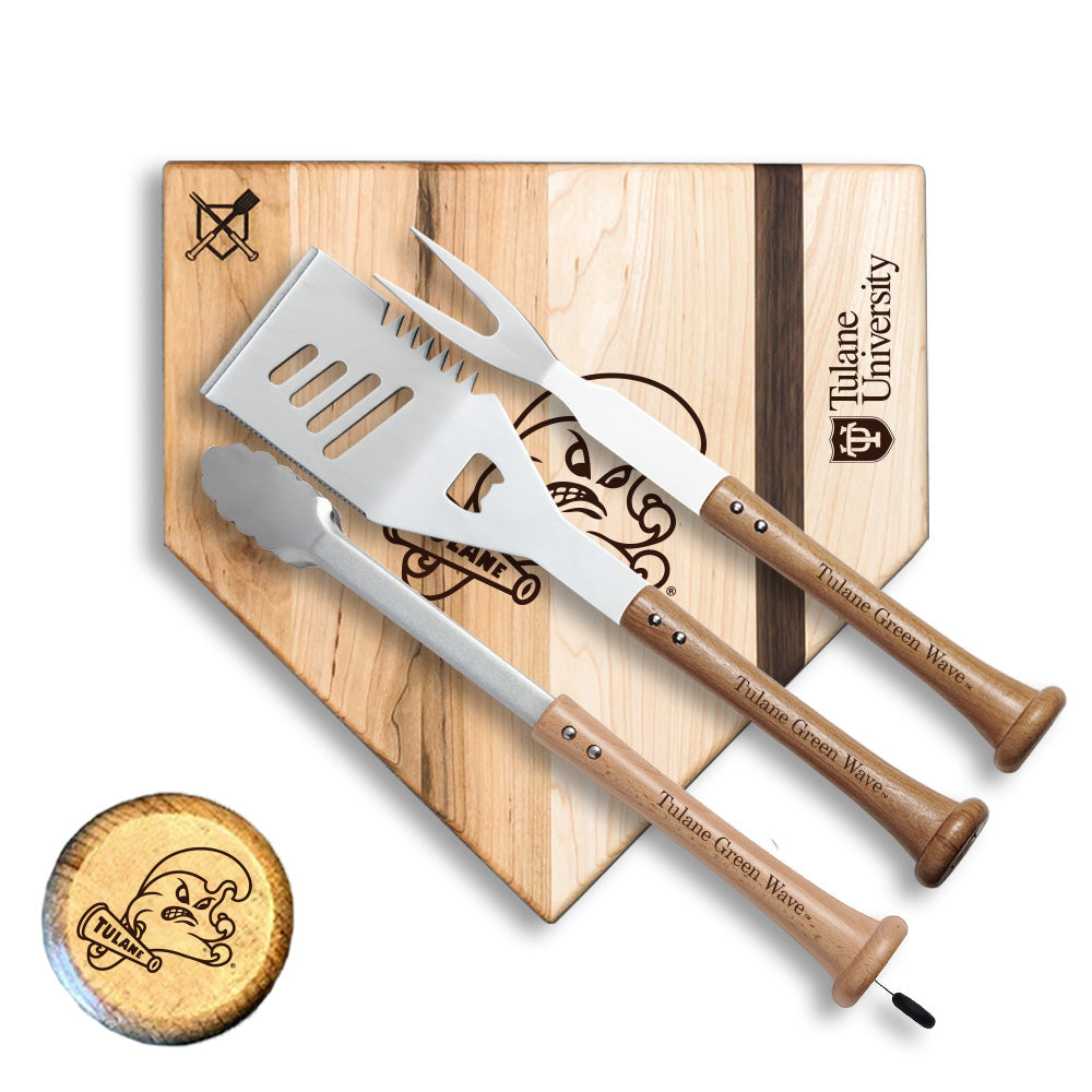 Set of barbecue utensils with wooden handles on a cutting board with Tulane University branding.