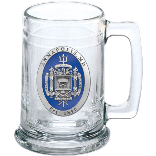 A clear glass stein with a blue and silver United States Naval Academy crest design, featuring a handle and a branded logo.