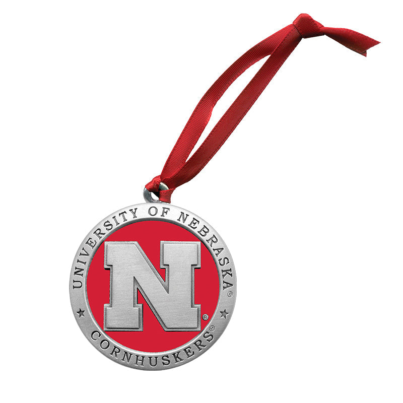 Decorative ornament with 'University of Nebraska Cornhuskers' logo on a red background