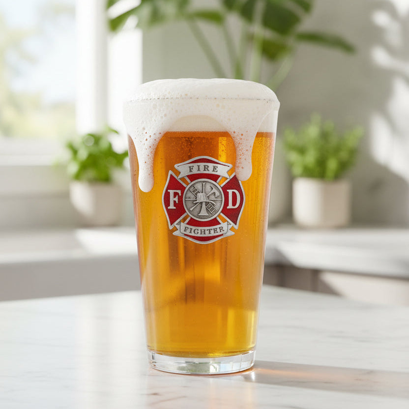 A classic 16-ounce glass pint featuring a detailed 3D sculpted fine pewter firefighter emblem, handcrafted in the USA.